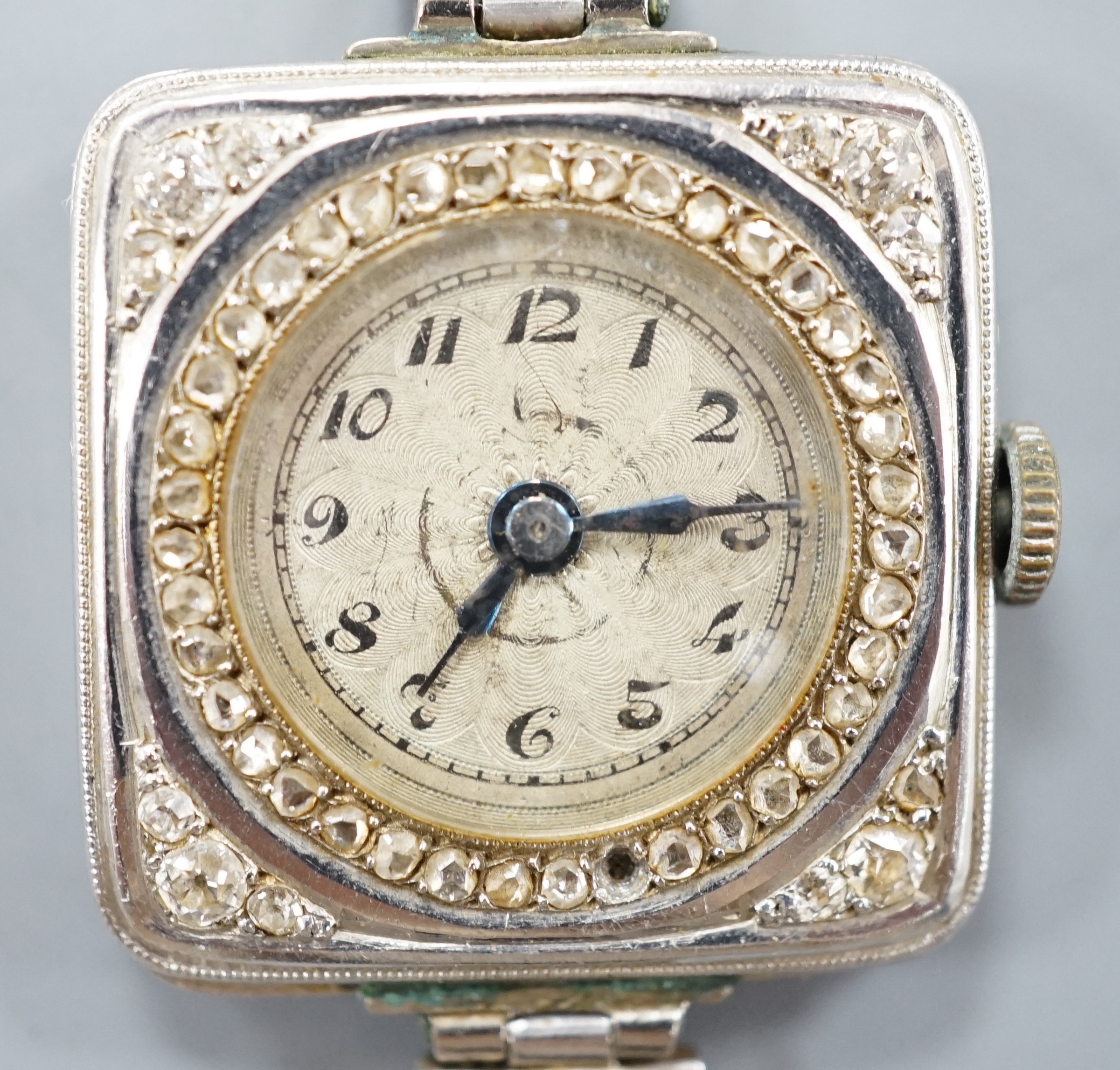 A lady's early 20th century white metal (stamped Plat) and diamond chip set manual wind cocktail watch, on a later 9ct white gold mesh link bracelet, gross 26.3 grams, (stone missing).